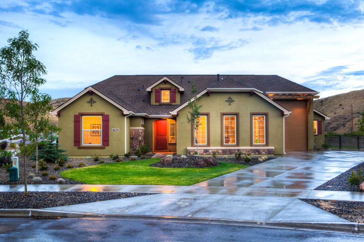 A tidy front yard and clean driveway at dusk