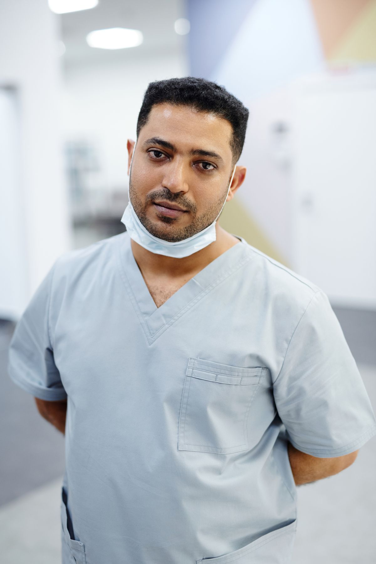 Dr. Daniel Reyes in scrubs, standing in the Bright Creek Dental office