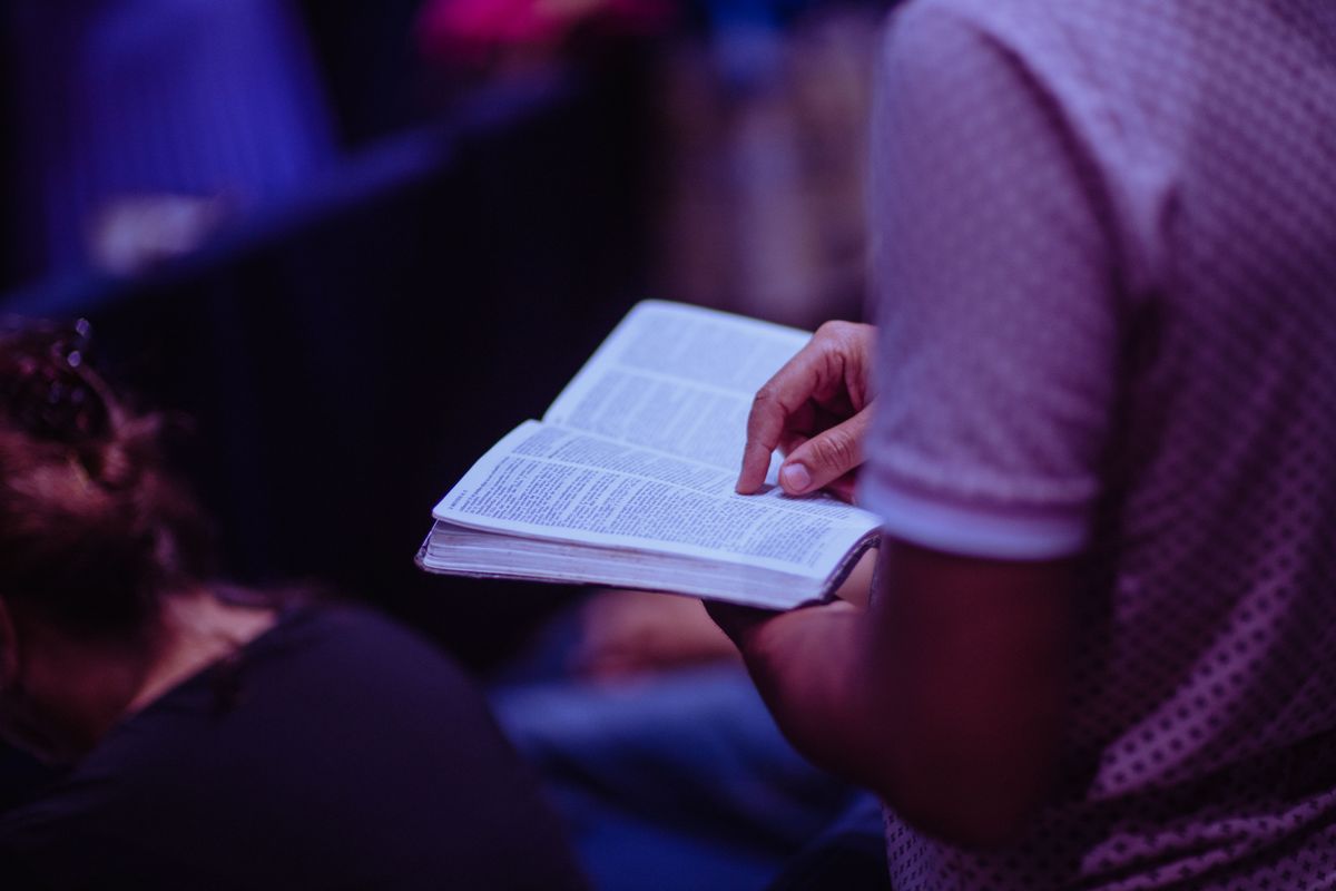 A student reading an open Bible