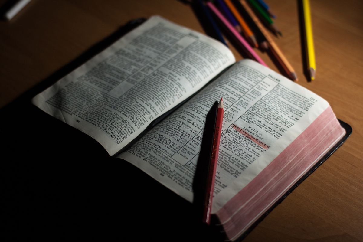 An open Bible and notes on a table