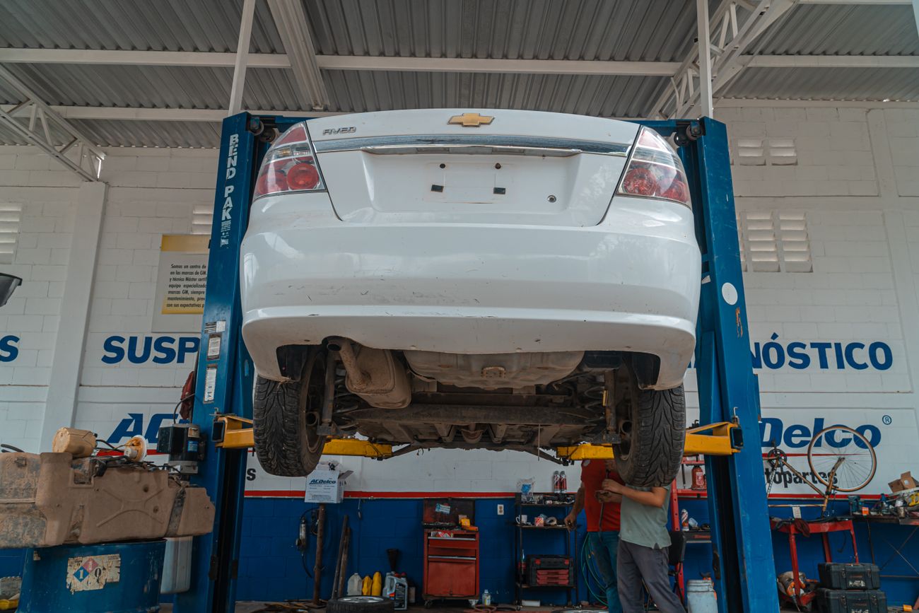 A vehicle on a lift in the service bay