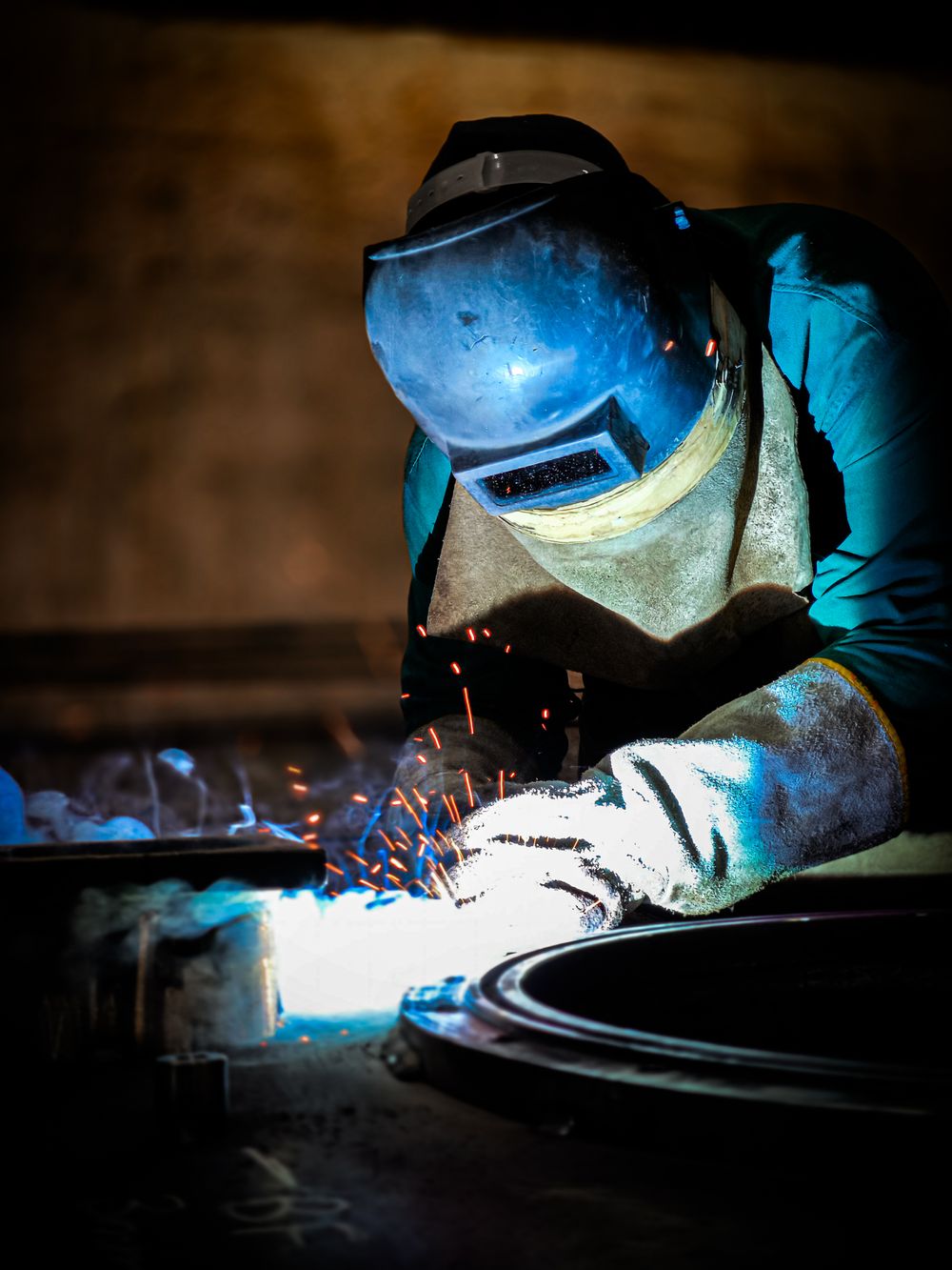 A welder joining metal with sparks