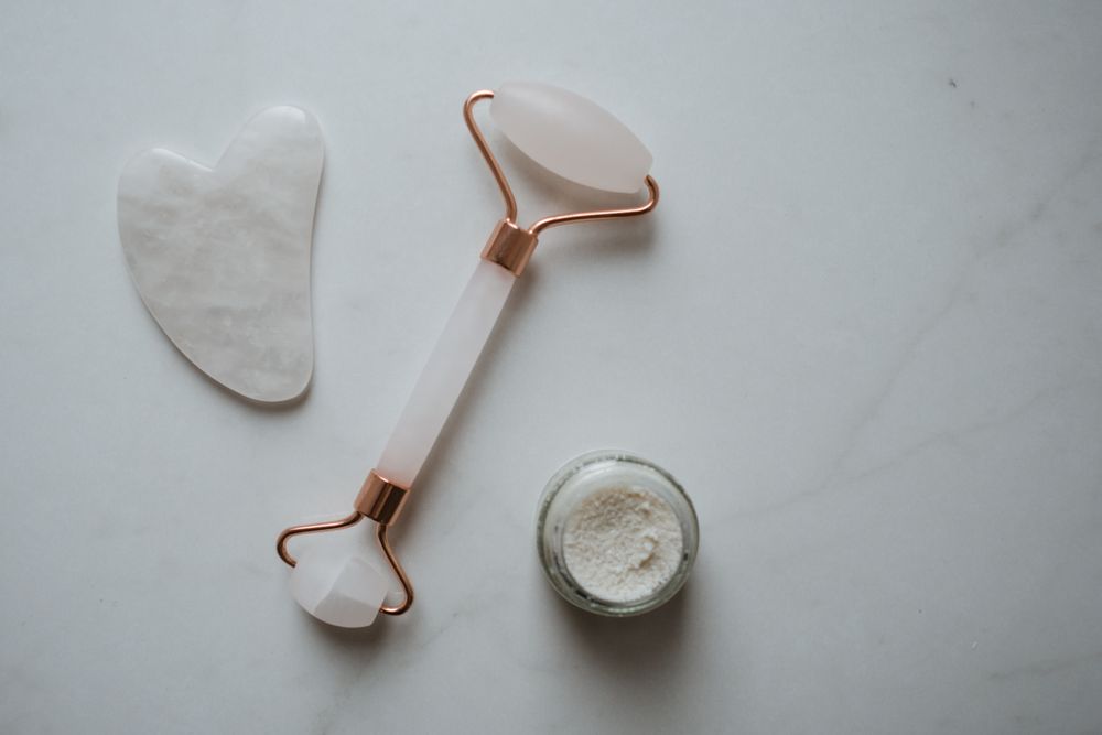 Facial tools resting on a marble surface