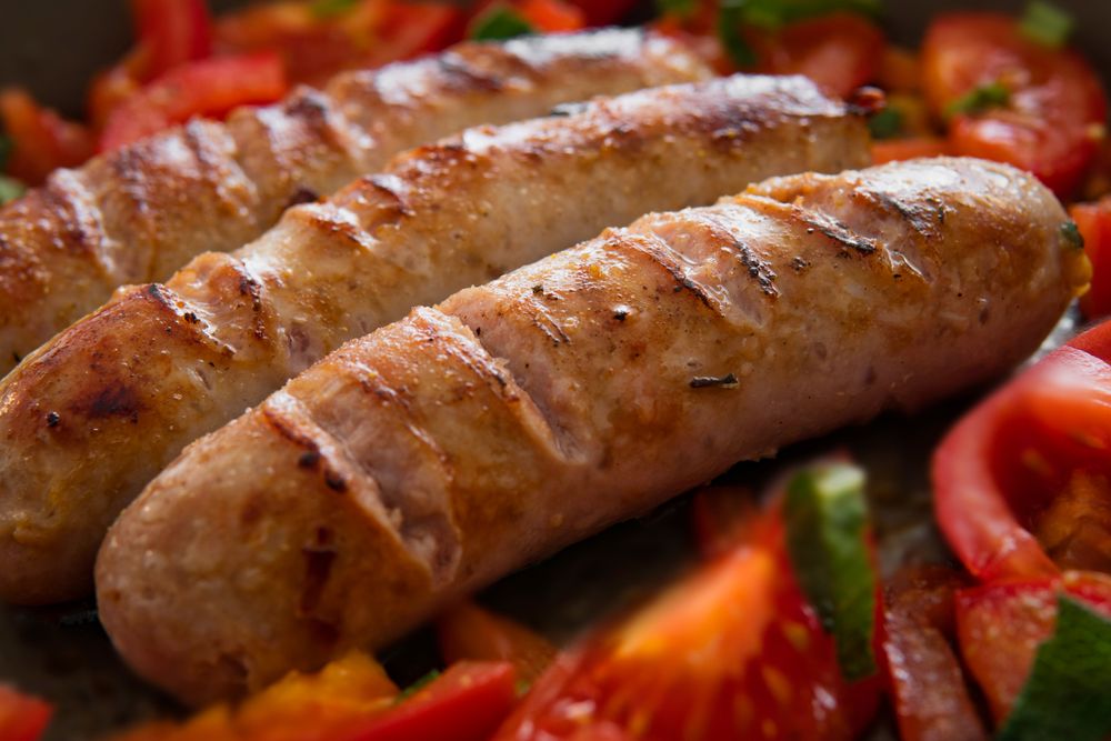 Grilled sausage links with charred casing.