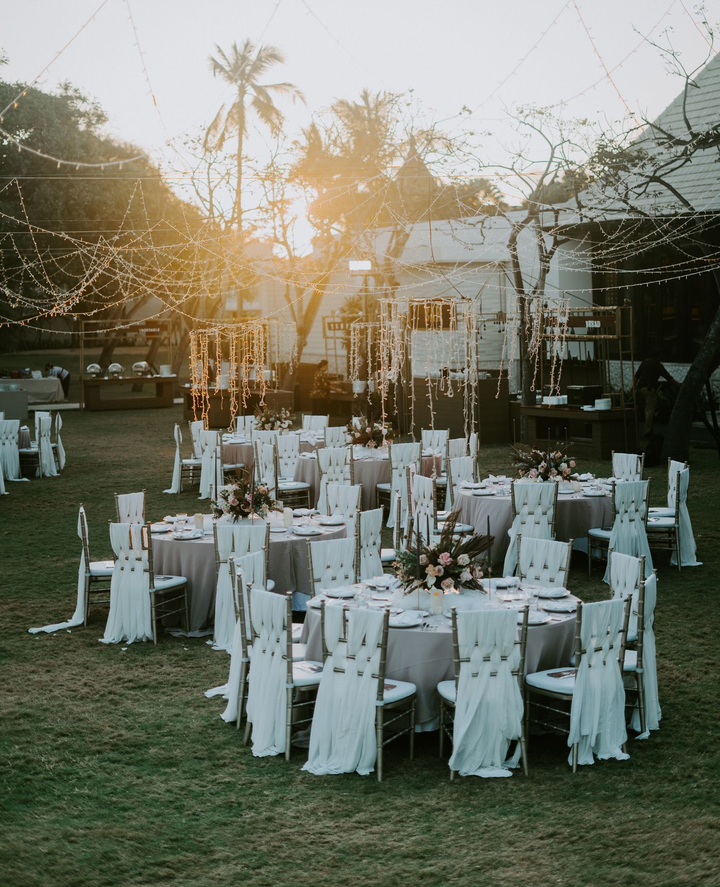 The garden at dusk, set for a reception under string lights